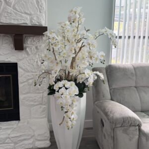 Cascading white orchids, white vase