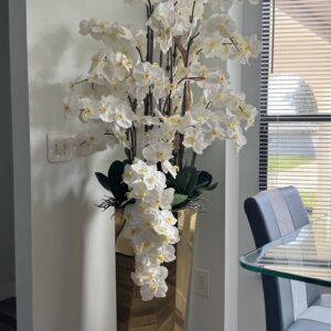 Cascading white orchids, gold beveled vase