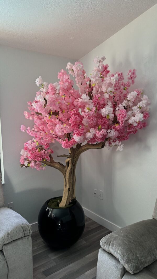 Pink cherry blossom tree on a black round vase