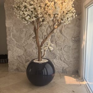 White cherry blossom tree on a dark blue vase