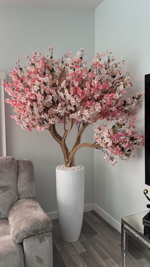 Pink cherry blossom on a tall white vase