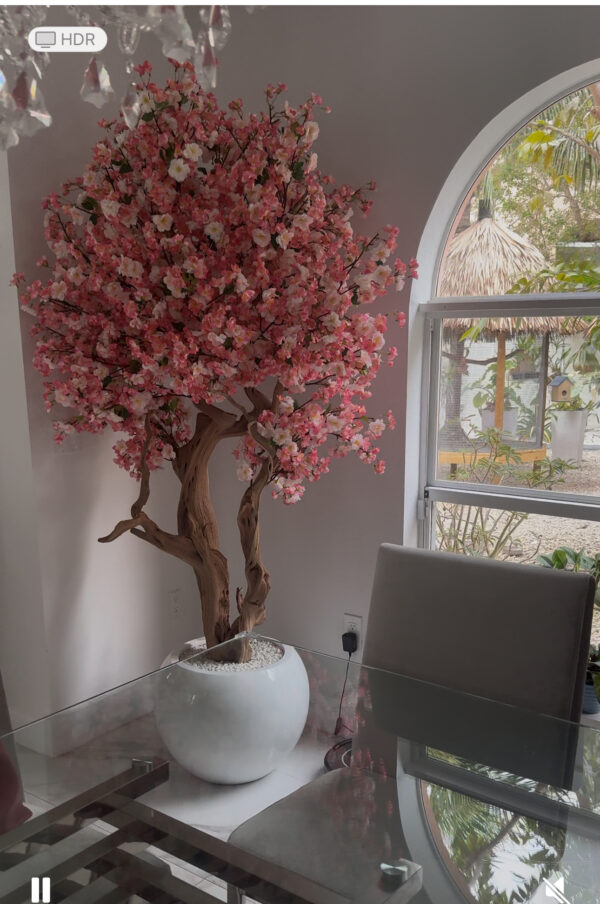 Pink cherry blossom tree on a  glossy white round vase