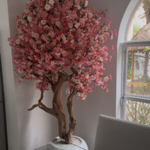 Pink cherry blossom tree on a  glossy white round vase
