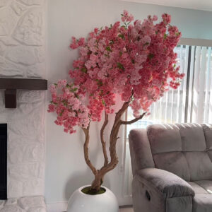 Pink cherry blossom tree on a white round vase
